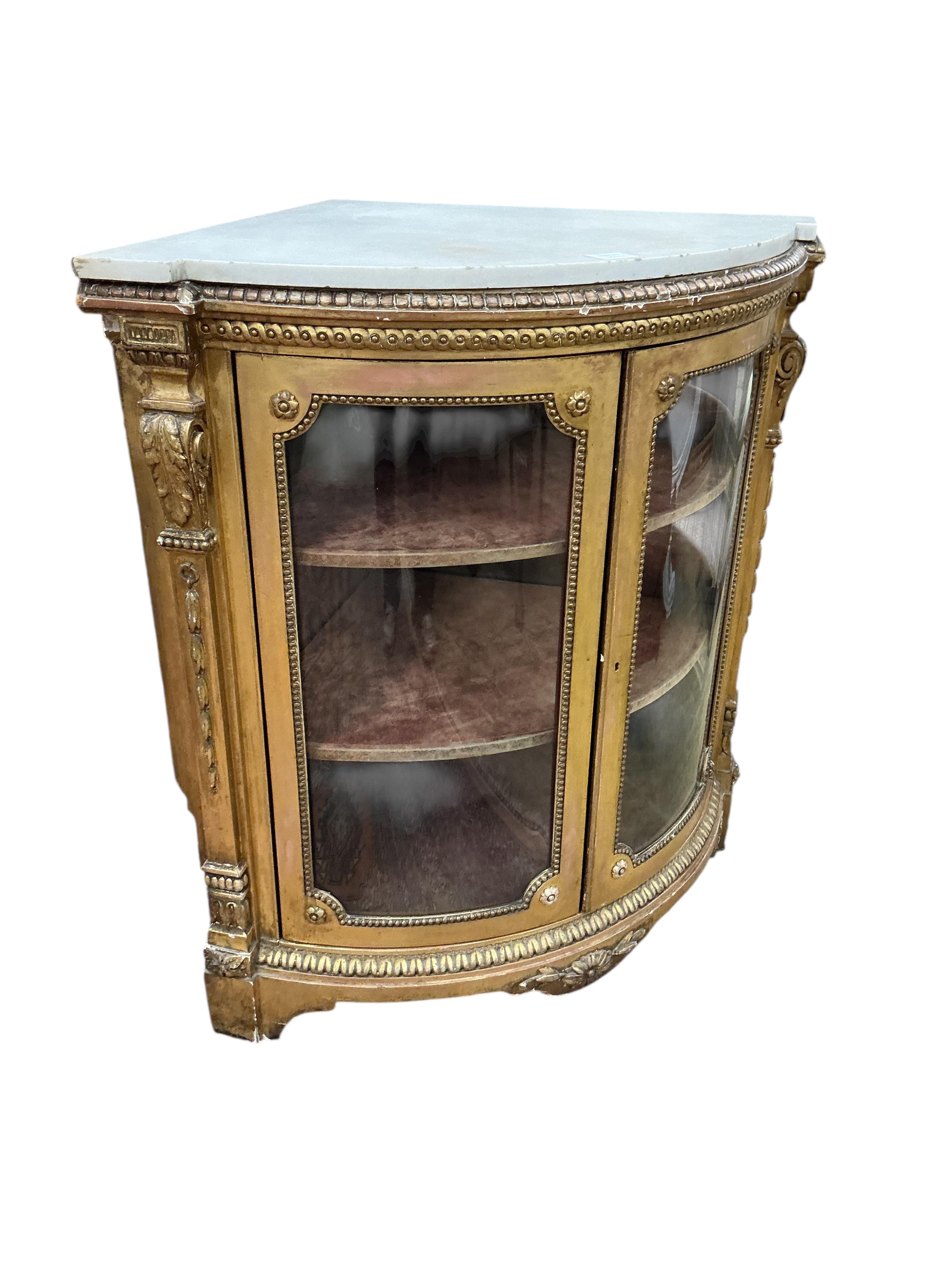 A Louis XVI style giltwood and composition marble topped corner cabinet, width 94cm, depth 69cm, height 95cm